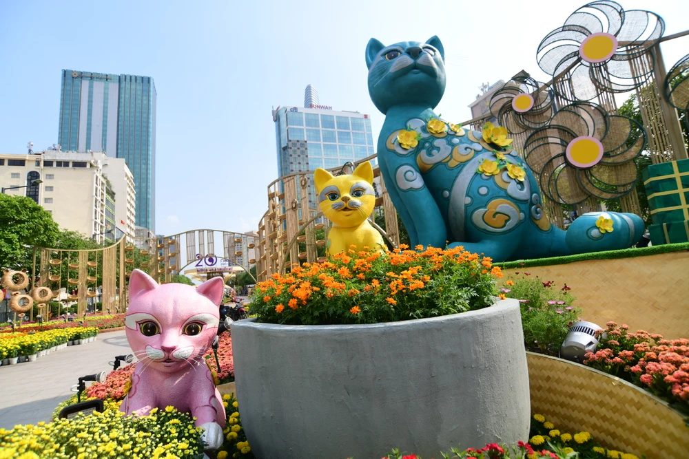 Tại cổng chính, các linh vật mèo đã được công nhân chuyển từ xưởng ra đường hoa. Linh vật mèo cao 0,8-4,5 m, tạo hình bằng xốp, sơn bề mặt giả gốm. Ảnh: HOÀNG GIANG