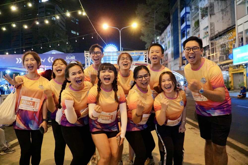 Chị Trần Khánh Ngọc, ngụ quận 4 (thứ 4, từ phải sang) cho biết đây là lần đầu tiên chị tham gia một giải chạy chuyên nghiệp. "Mình quyết định tham gia giải chạy đêm này vì muốn thử sức bản thân, mình cũng đến tham gia giải chạy cùng bạn bè vì muốn cùng nhau tạo nên những kỷ niệm đẹp, cùng nhau rèn luyện sức khỏe"- chị Ngọc chia sẻ. Ảnh: BẢO PHƯƠNG