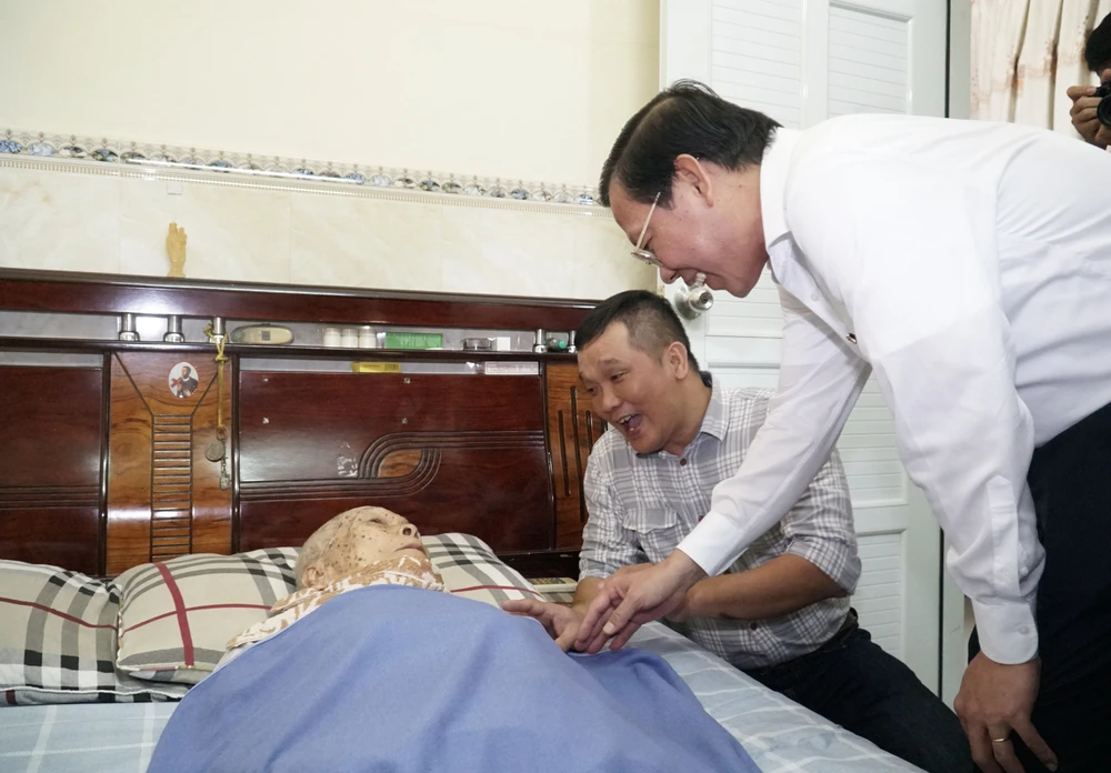 Chủ tịch UBND TP.HCM Phan Văn Mãi thăm hỏi sức khỏe cụ Trần Văn Tám, cha liệt sỹ. Ảnh: BẢO PHƯƠNG