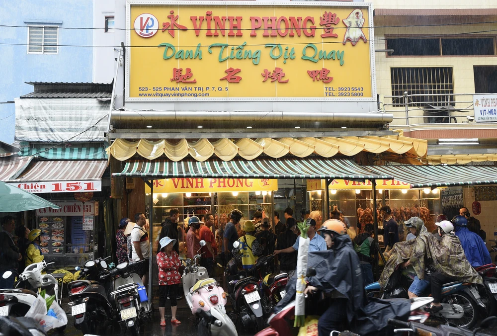 Thần tài, vịt quay-heo quay- vía Thần tài - PLO- TP.HCm - người dân-xếp hàng-mưa