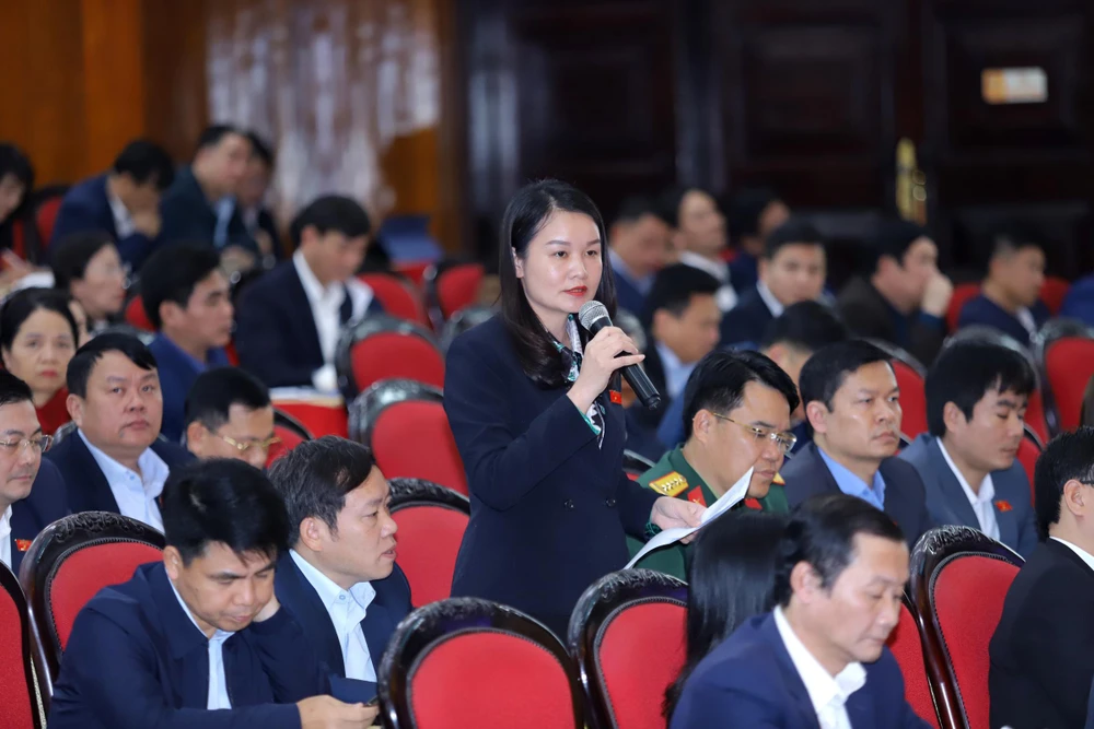 Đại biểu Hà Thị Hương huyện Quan Hóa chất vấn Thiếu tướng Trần Phú Hà xung quanh việc tội phạm lừa đảo qua mạng dưới hình thức tặng quà. Ảnh: Đ. TRUNG