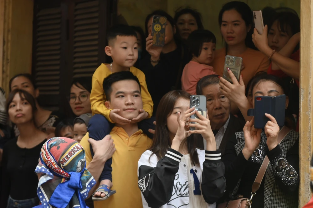 Khi đoàn rước đi qua các ngõ xóm, mỗi gia đình hai bên đường đều phải mở cửa để rước Thánh vào nhà. ẢNH: HOÀNG ANH