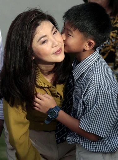 Supasek Amornchat kisses his mother Yingluck Shinawatra during her birthday at their house in Bangkok June 21, 2011. Yingluck Shinawatra is the sister of toppled former Thai premier Thaksin Shinawatra and the prime ministerial candidate for the country's biggest opposition Puea Thai party. REUTERS