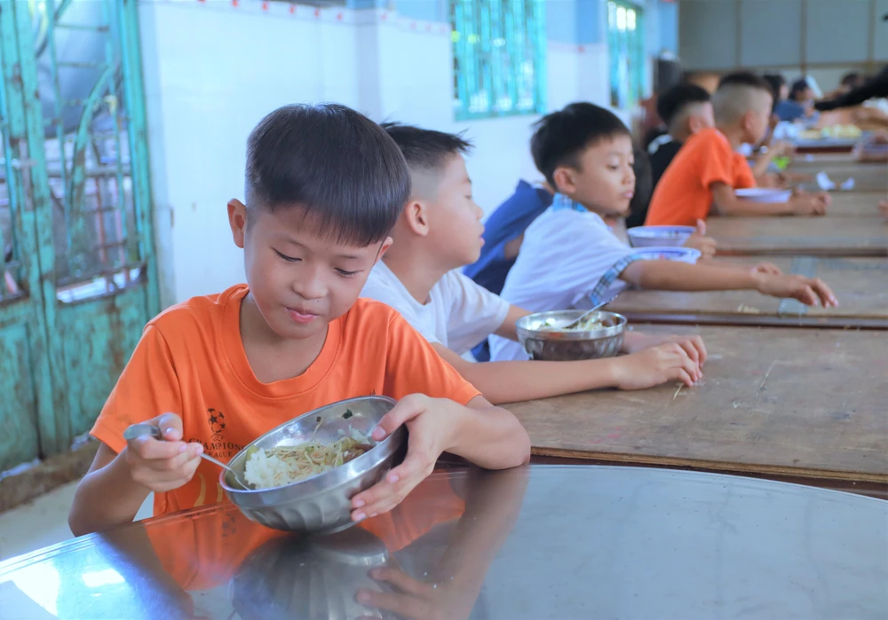 Các em vui vẻ bên phần cơm hằng ngày tại mái ấm. Ảnh: HUỲNH DU