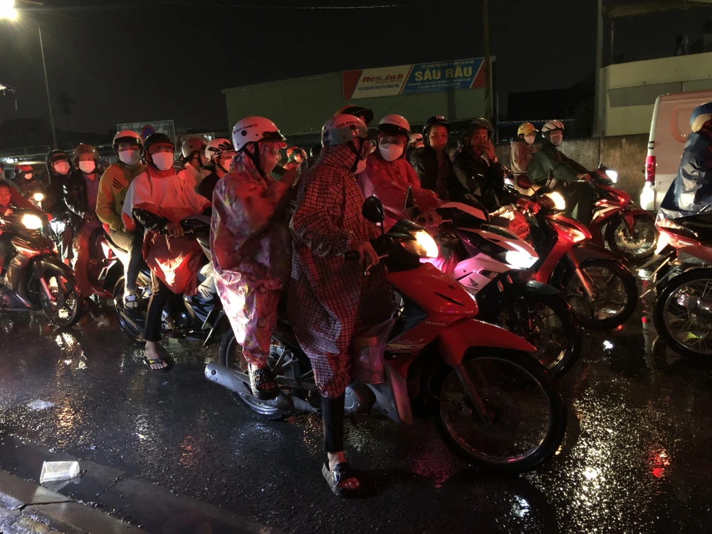 Nhiều dân dầm mưa về miền Tây nghỉ lễ 2-9 trong tối qua 31-8. Ảnh: HUỲNH DU
