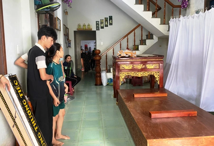 Hai đứa trẻ con chị Xinh đứng thẩn thờ vì mẹ mất, cha bị thương nặng. Ảnh: HẢI HIẾU