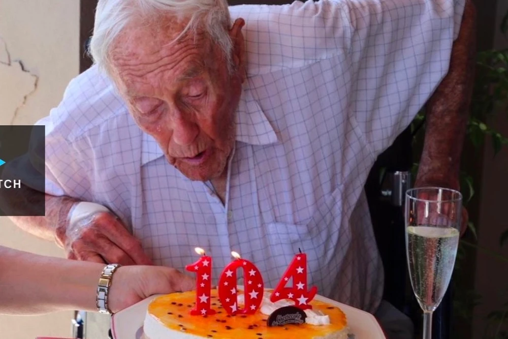 Nhà khoa học Goodall trong ngày sinh nhật thứ 104. Bánh sinh nhật được làm bằng phomai, món ông thích. Ảnh: GOFUNDME