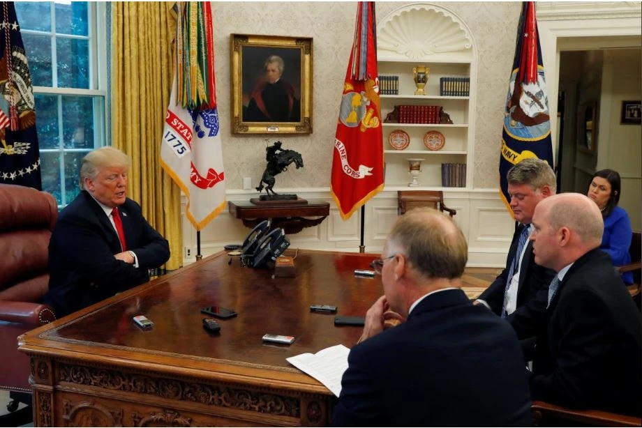 Tổng thống Mỹ Donald Trump (trái) trong buổi trả lời phỏng vấn các nhà báo Reuters tại Nhà Trắng ngày 20-8. Người phát ngôn Nhà Trắng Sarah Sanders (áo xanh) ngồi đằng sau. Ảnh: REUTERS