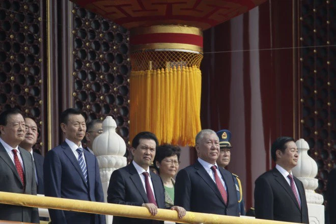 Trưởng Đặc khu Hong Kong Lâm Trịnh Nguyệt Nga (giữa, hàng thứ hai) đứng cùng các quan chức Trung Quốc tại cổng Thiên An Môn ở Bắc Kinh trước khi lễ diễu binh kỷ niệm Quốc khánh lần thứ 70 bắt đầu sáng nay 1-10. Ảnh: REUTERS