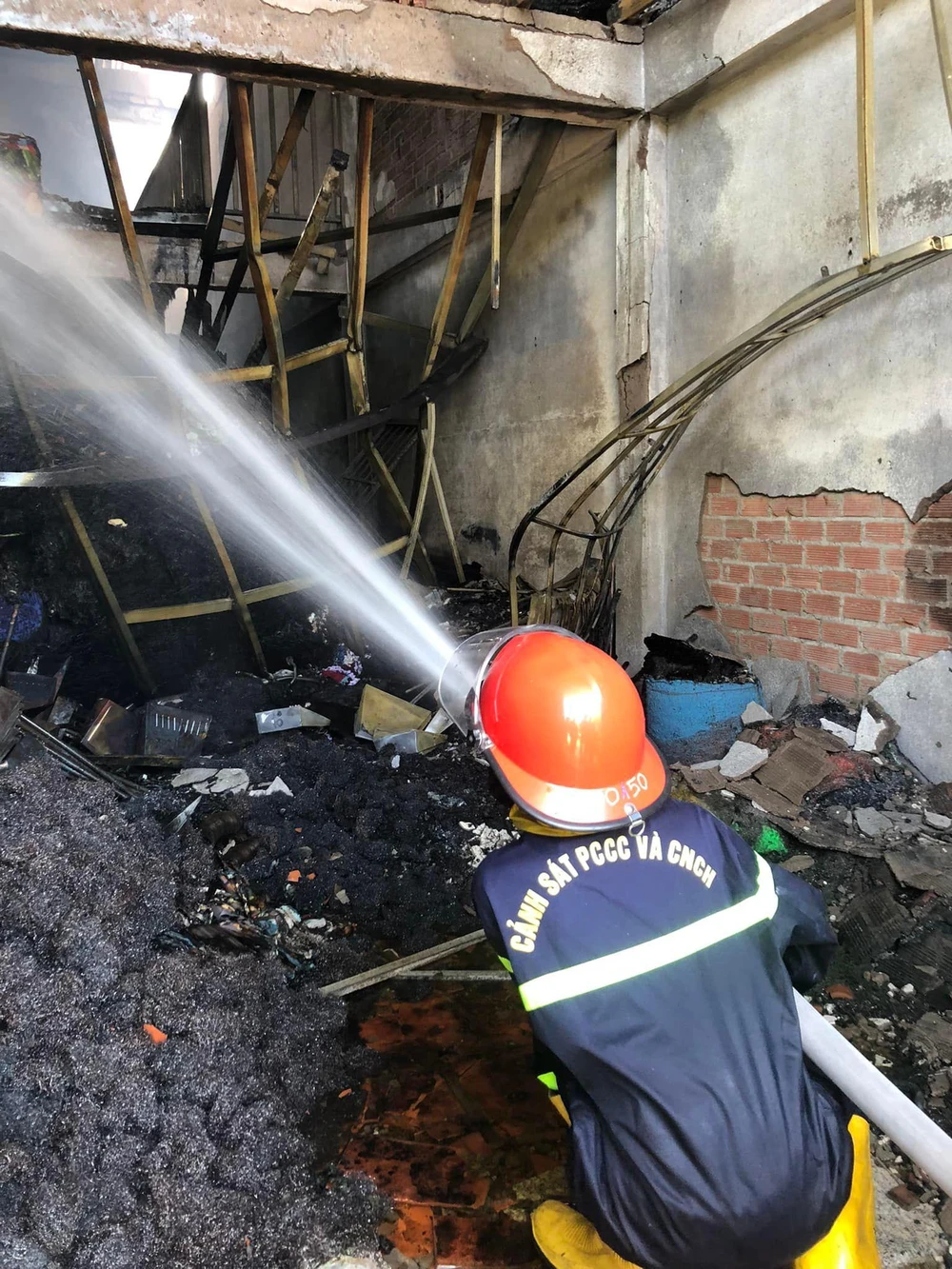 Lực lượng chữa cháy tiếp cận hiện trường tìm kiếm các nạn nhân nghi mắc kẹt. Ảnh: CÔNG AN.