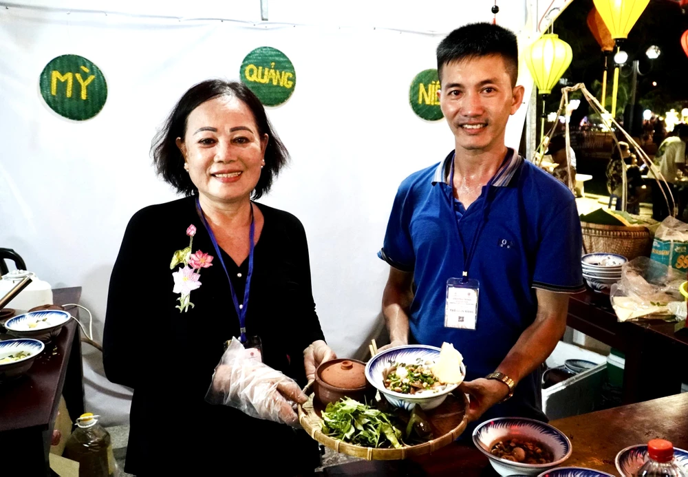 Anh Cảnh và món mì Quảng niêu độc lạ với du khách. Ảnh: CHU VÂN