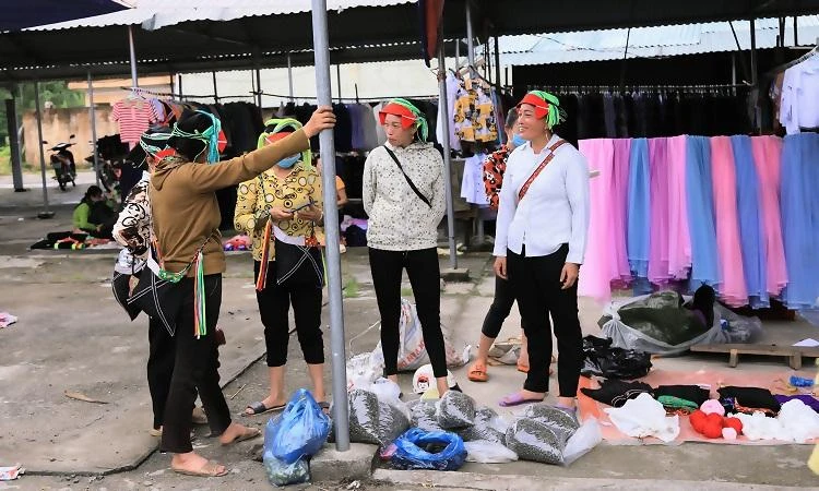 Người dân tộc Dao tại chợ phiên Phương Độ - TP Hà Giang mang đến những sản vật của mình. Ảnh: NÚI XANH