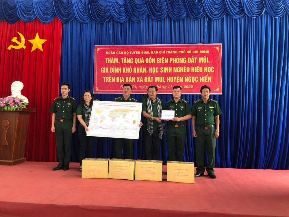 Đoàn trao tặng sách, tiền mặt và bản đồ 30 năm tìm đường cứu nước của Bác Hồ cho Đồn biên phòng Đất Mũi. Ảnh: Q.HUY