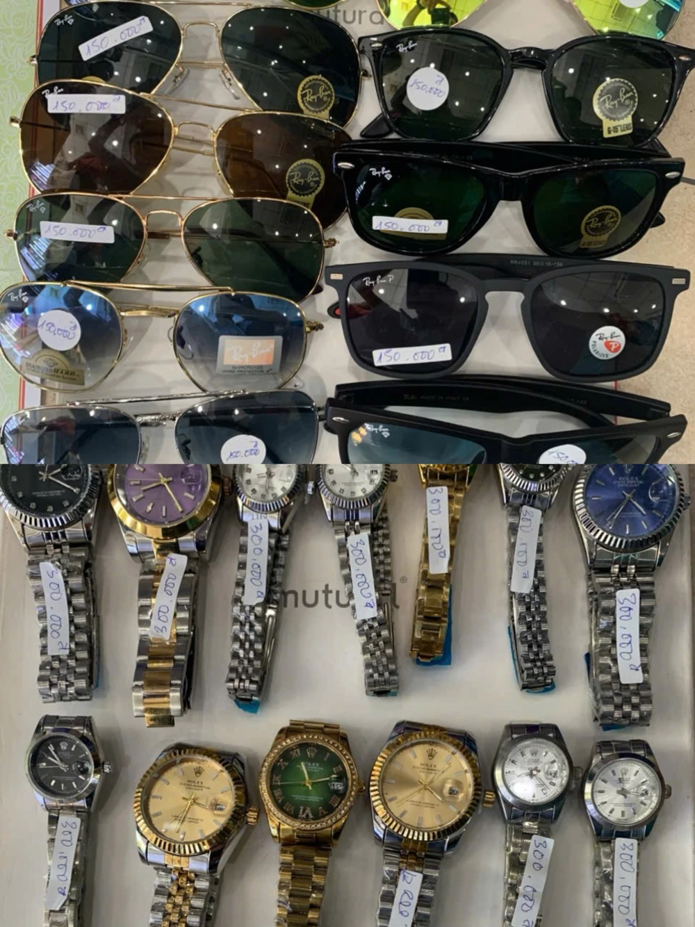 Lực lượng chức năng tạm giữ số lượng mắt kính, đồng hồ tại một cửa hàng. ẢNH: HỒNG THẮM