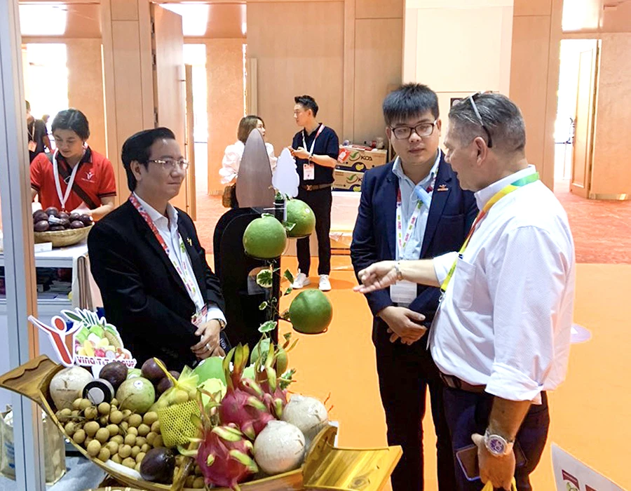 Khách hàng nước ngoài đang tìm hiểu về mặt hàng rau quả xuất khẩu của Việt Nam.Ảnh: QUANG HUY