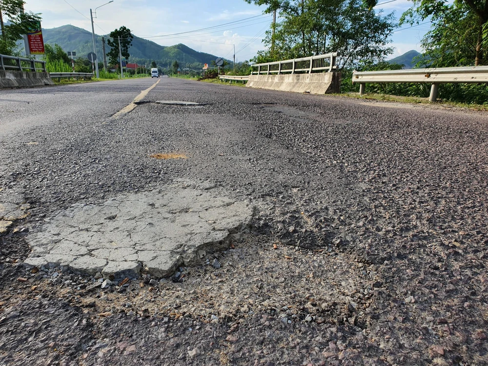 Hàng loạt điểm bong tróc, lồi lõm trên mặt đường. Ảnh QN