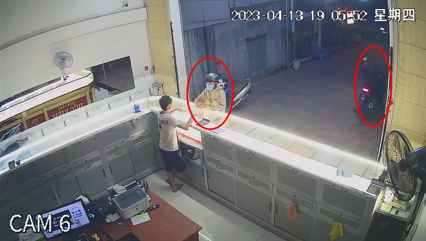 Trong khi một nam thanh niên đang xem vàng, thì một nam thanh niên đã nổ máy xe đợi sẵn bên ngoài. Ảnh: Cắt từ camera Trong khi một nam thanh niên đang xem vàng, thì một nam thanh niên đã nổ máy xe đợi sẵn bên ngoài. Ảnh: Cắt từ camera