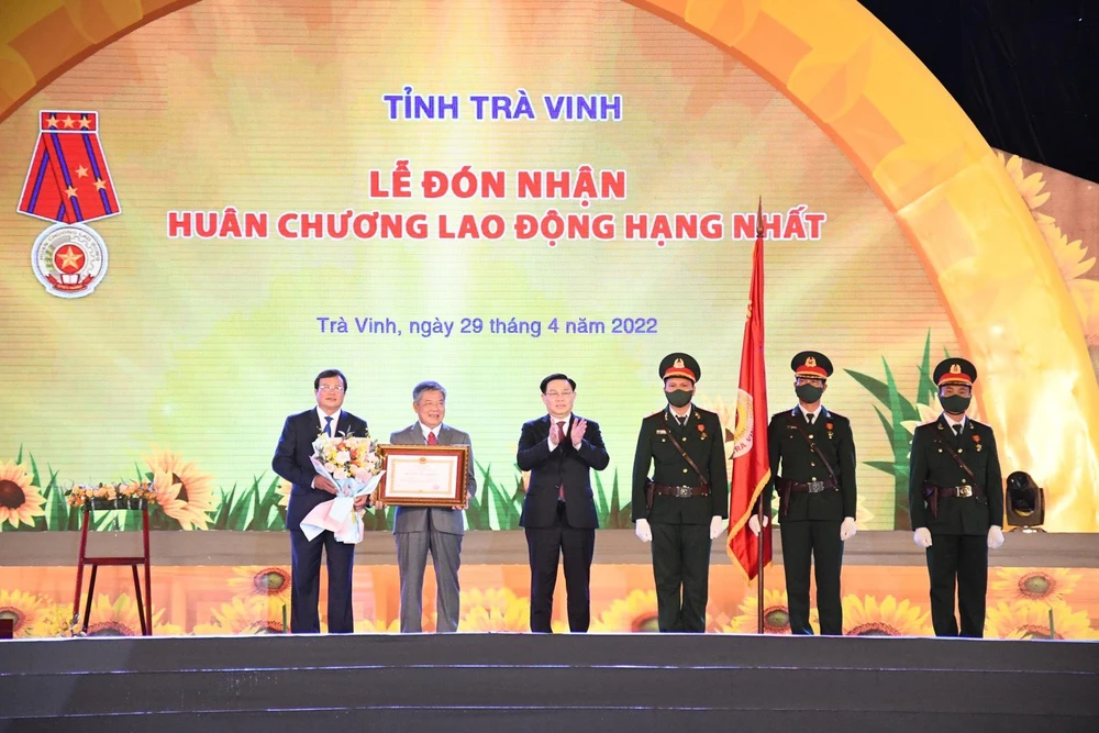 Thay mặt lãnh đạo Đảng, Nhà nước, Chủ tịch Quối hội Vương Đình Huệ trao Huân chương Lao động Hạng Nhất cho Đảng bộ, chính quyền và nhân dân tỉnh Trà Vinh. Ảnh: HỒ GIANG