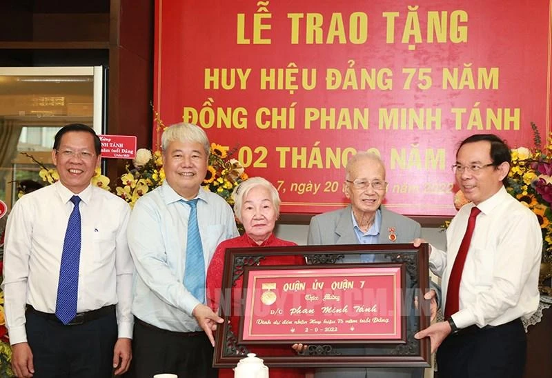 Bí thư Thành uỷ TP.HCM Nguyễn Văn Nên cùng lãnh đạo TP, lãnh đạo quận 7 trao tặng huy hiệu cho ông Phan Minh Tánh. Ảnh: Website Thành uỷ TP.HCM