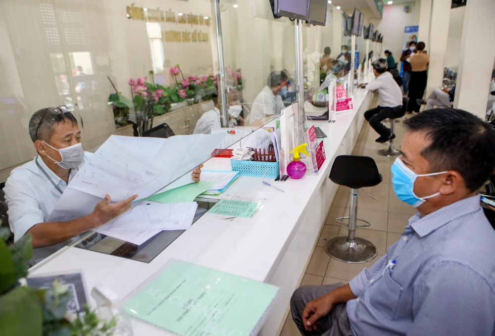 Cán bộ quận Bình Tân đang giải quyết hồ sơ cho người dân. Ảnh: NGUYỆT NHI Cán bộ quận Bình Tân đang giải quyết hồ sơ cho người dân. Ảnh: NGUYỆT NHI