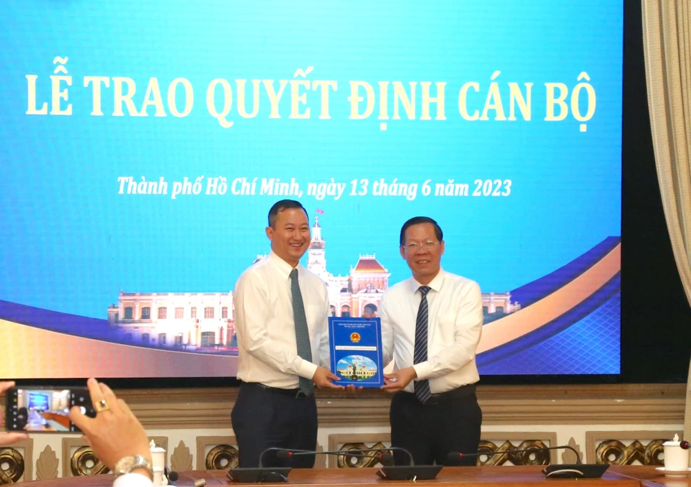 Chủ tịch UBND TP.HCM Phan Văn Mãi trao quyết định cho ông Trần Phú Lữ. Ảnh: T.THẢO