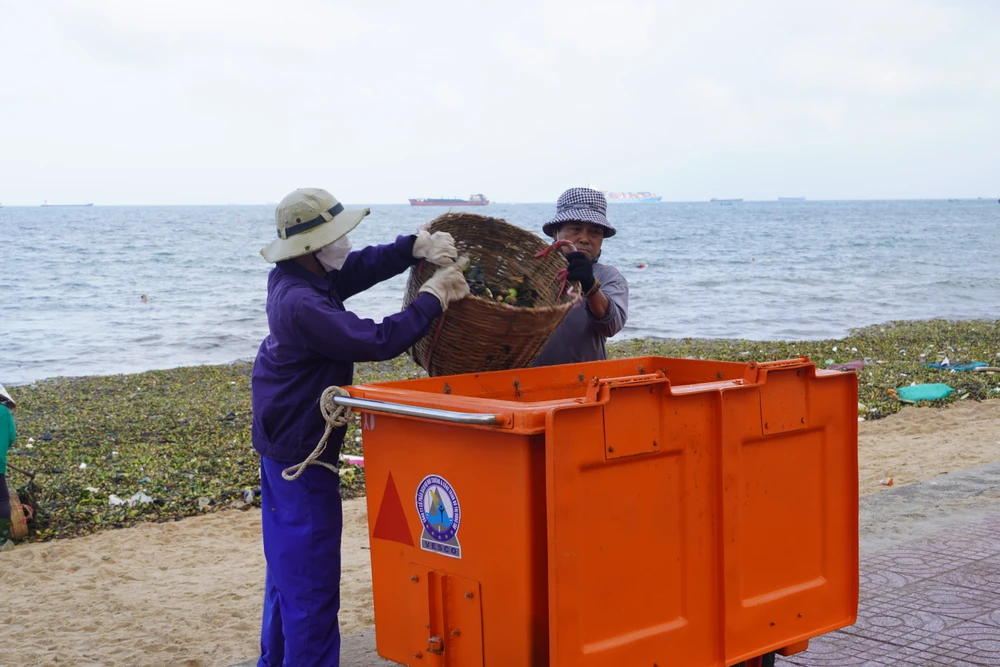 Nhân viên môi trường thu gom rác tại Bãi Trước. Ảnh: TĐ