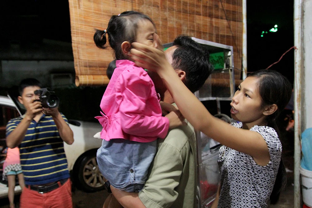 Mẹ nuôi Thu Trang dỗ con gái Lan Anh để con trở về nhà mới. Ảnh: HOÀNG GIANG