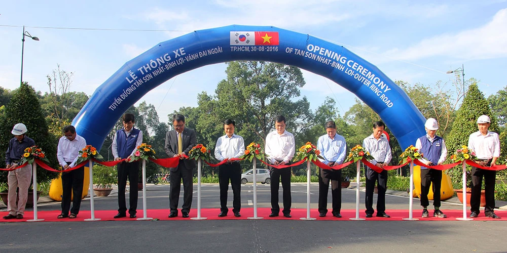 Các đại biểu thực hiện nghi thức thông xe tuyến đường Tân Sơn Nhất - Bình Lợi - Vành đai ngoài, sáng 30-8.