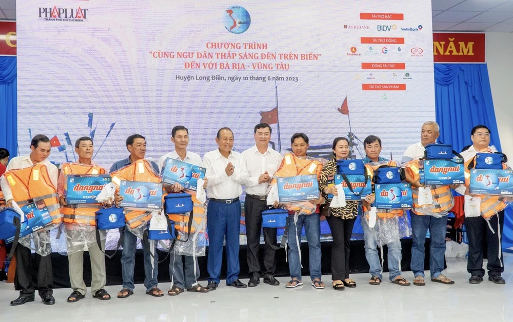 Chương trình tặng quà cho 200 ngư dân tỉnh Bà Rịa - Vũng Tàu. Bộ quà tặng gồm một bộ ắc quy + đèn Led và túi thuốc chống nước trị giá bốn triệu đồng; một áo phao và cẩm nang “Những điều cần biết về đánh bắt hải sản” do Báo Pháp Luật TP.HCM chủ biên với rất nhiều kiến thức về pháp lý cần thiết dành cho bà con ngư dân. Trong ảnh: Nguyên Phó Thủ tướng Thường trực Trương Hoà Bình và ông Nguyễn Công Vinh, Phó Chủ tịch UBND tỉnh Bà Rịa – Vũng Tàu trao quà cho các ngư dân. Ảnh: Nhóm PV