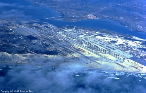 This view of Cam Ranh is from the East. The two runways, aligned 02-20, are visible in the center of the picture. West runway was 10,000 feet of concrete, while the East runway was 10,000 feet of aluminum planking. The C-7A squadrons were based on the East side with the aircraft parking area to the lower left of the runways. The beach shown in the next picture is the one which can be seen under the clouds at the bottom.