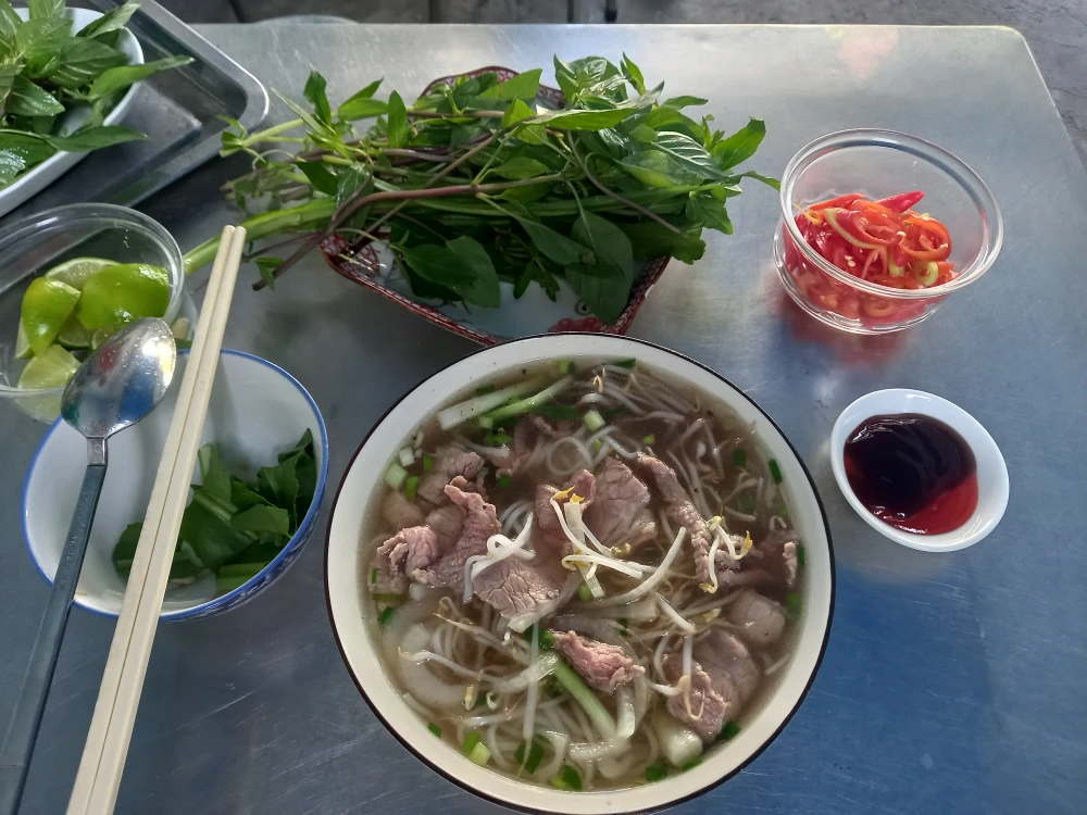 Tôi cầm đũa bắt đầu thưởng thức bát phở Sài Gòn mà lần đầu tiên được thưởng thức. Ảnh: NGUYỄN ĐƯỚC