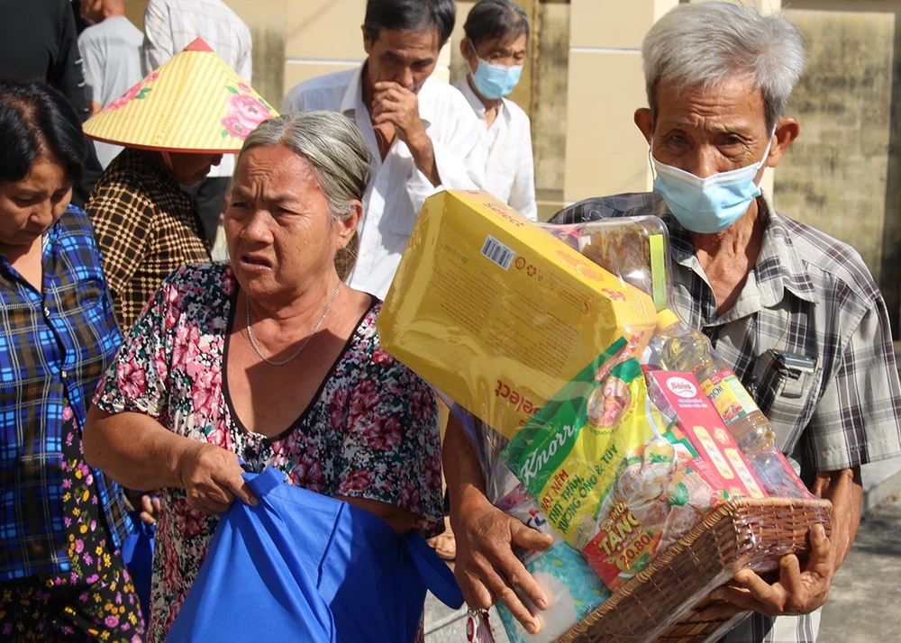 Bà con hạnh phúc với túi quà tết vừa được nhận.jpg