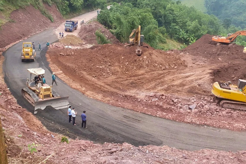 Các công nhân khẩn trương hoàn thành tuyến đường tạm.