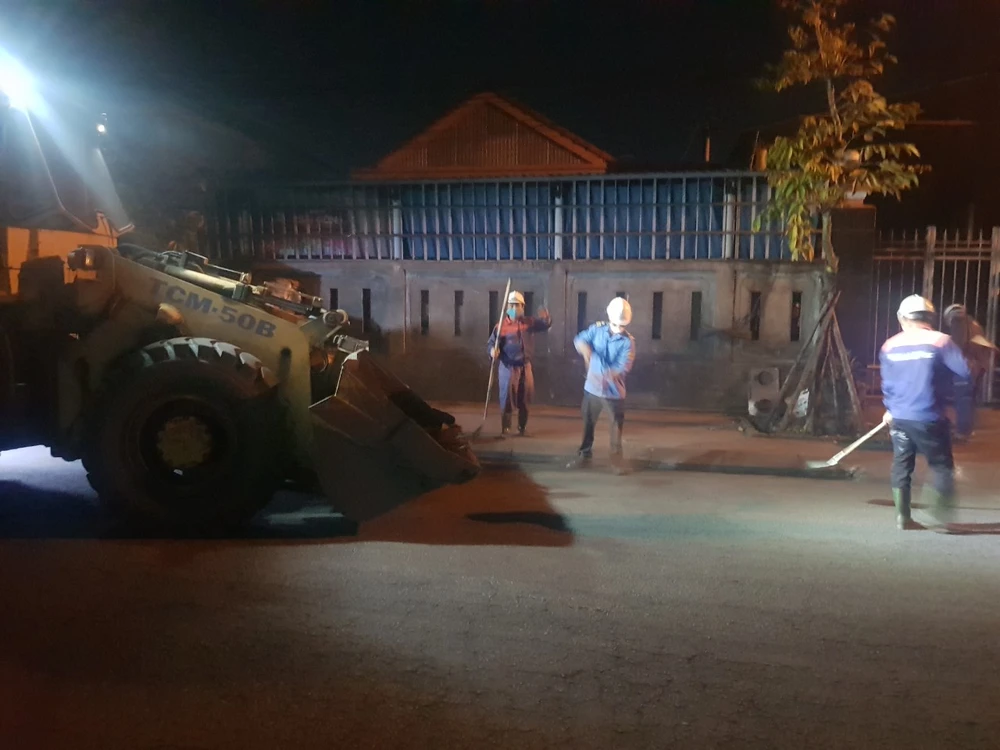 Công nhân vệ sinh môi trường, thu dọn than rơi vãi ở đường vào cảng.