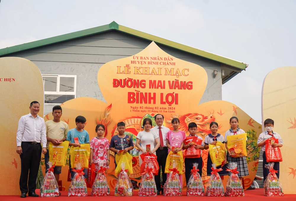 Lãnh đạo huyện Bình Chánh trao quà tết cho các em học sinh. Ảnh: MINH HOÀNG