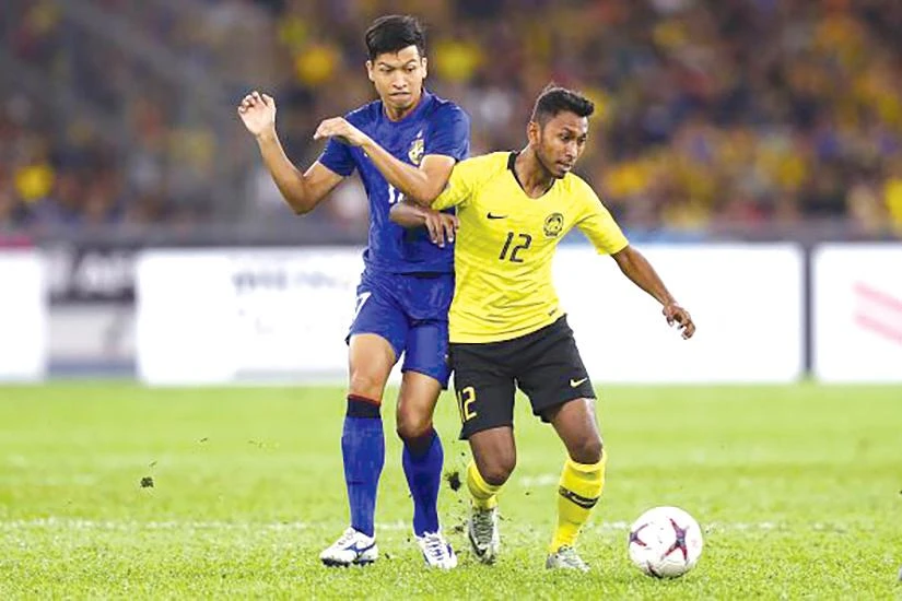 Akram Mahinan (12) không tập trung cùng đội tuyển Malaysia. Ảnh: TS