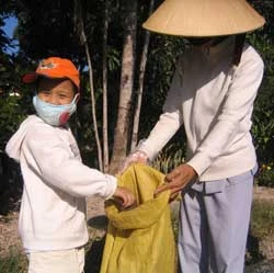 Cháu Đức Tuấn đi lượm rác với bà ngoại. Ảnh: Ngọc Hà