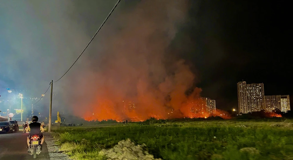 Bãi cỏ gần sân bóng bốc cháy dữ dội, người dân hoảng hốt di dời tài sản ở TP Thủ Đức