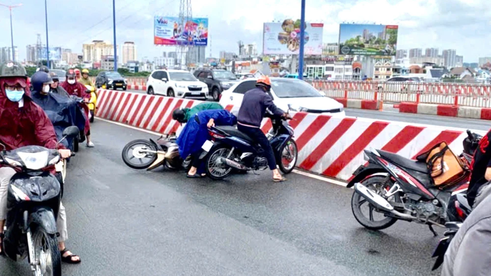Người đi xe máy trượt té hàng loạt trên cầu Sài Gòn do cơn mưa đám mây
