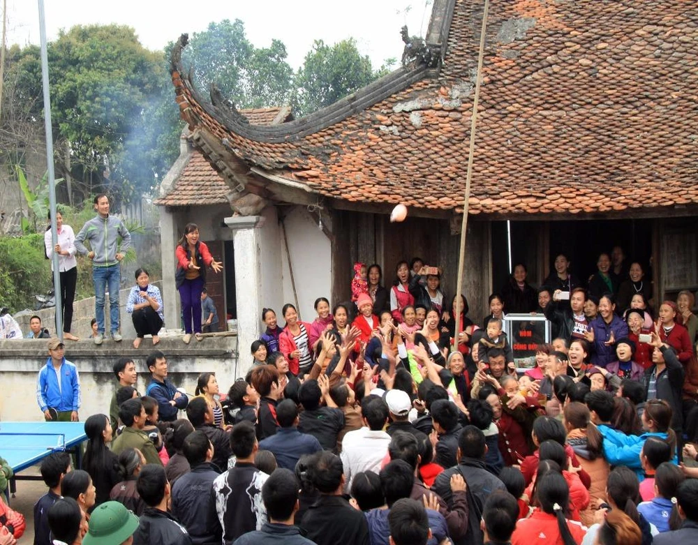 Sau khi tế xong, Quờ được mang ra sân tung lên cho người dân cướp