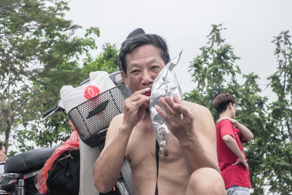 Tại khu vực ven hồ Tây đoạn trên phố Quảng Bá, phường Quảng An, quận Tây Hồ, có rất đông người dân đến tắm vào sáng sớm.