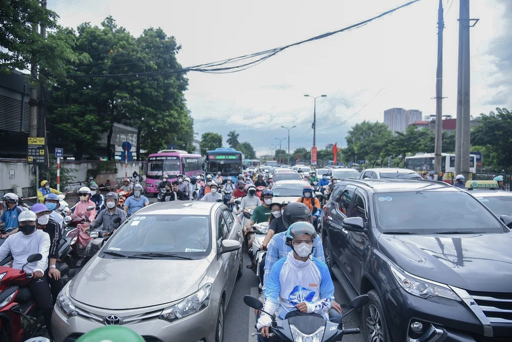 Trên đường Giải Phóng, các loại phương tiện chen chúc chờ đèn đỏ.