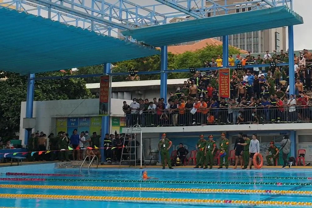 Trong quá trình thi đấu, một VĐV đã bị chuột rút, nhưng vẫn cố bám vào phao nổi để đưa hình nộm về đích. Ảnh: NT