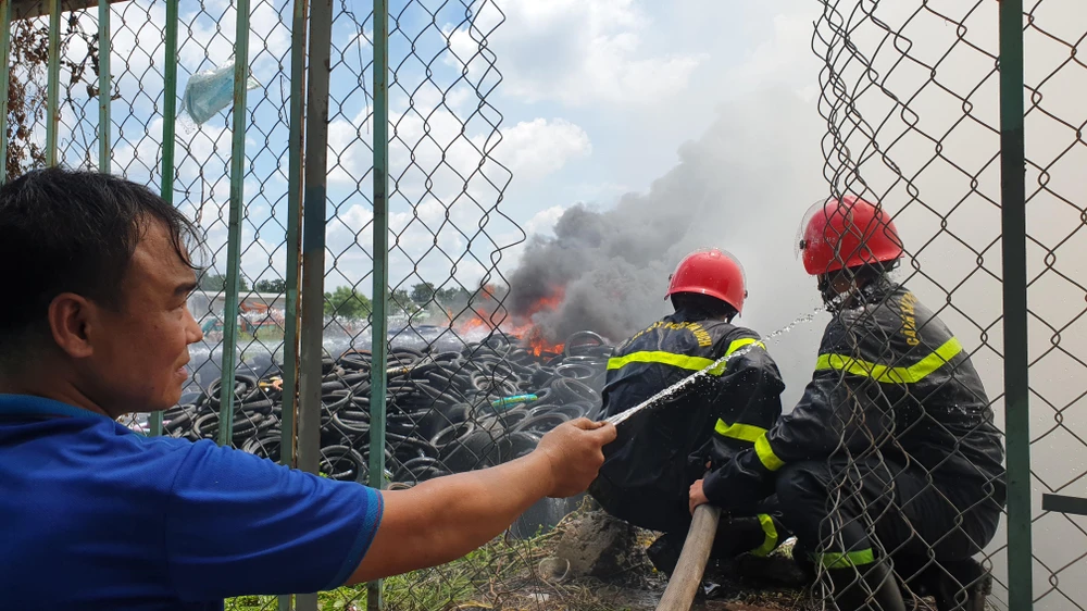 Người dân hỗ trợ xịt nước vào người các chiến sĩ CS PCCC để hạ nhiệt. Ảnh: NT Người dân hỗ trợ xịt nước vào người các chiến sĩ CS PCCC để hạ nhiệt. Ảnh: NT