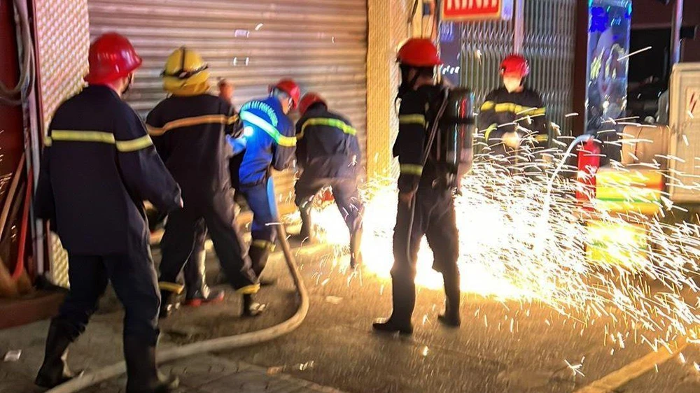 Cảnh sát phá cửa cuốn, tiếp cận vào bên trong căn nhà. Ảnh: CA