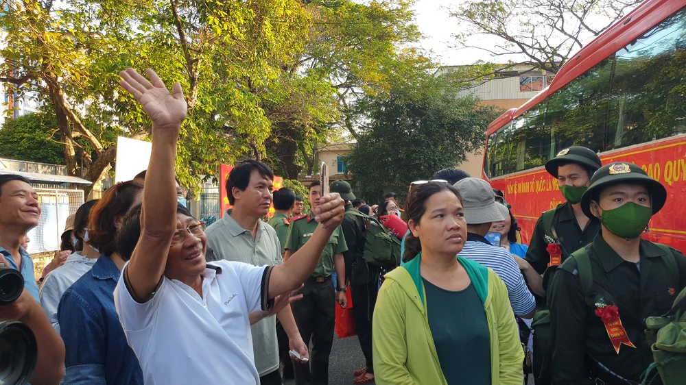 Nhiều cảm xúc xen lẫn khi người thân vẫy tay chào các tân binh lên đường.