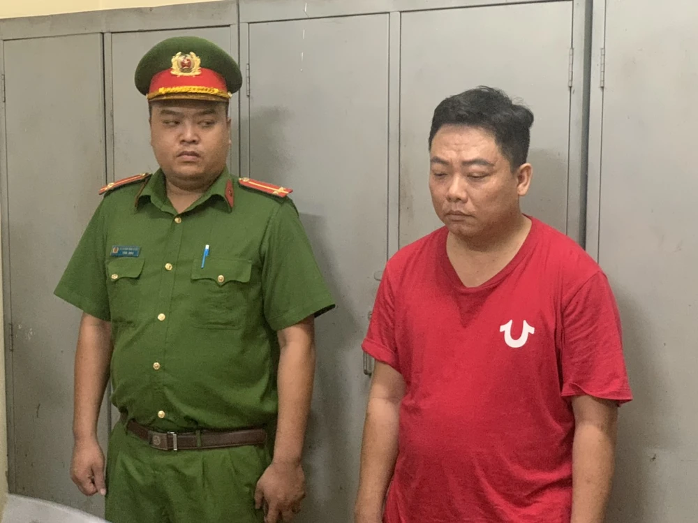 Võ Minh Điền (áo đỏ) tại cơ quan điều tra. Ảnh: CA