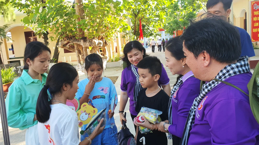 Đoàn công tác gửi tặng các em những món quà nhỏ khi ghé thăm đảo Sinh Tồn. Ảnh: NT