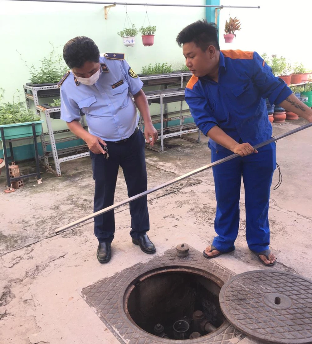 Kiểm tra, đo bồn tại một số cây xăng trên địa bàn TP.HCM. Ảnh: QLTT