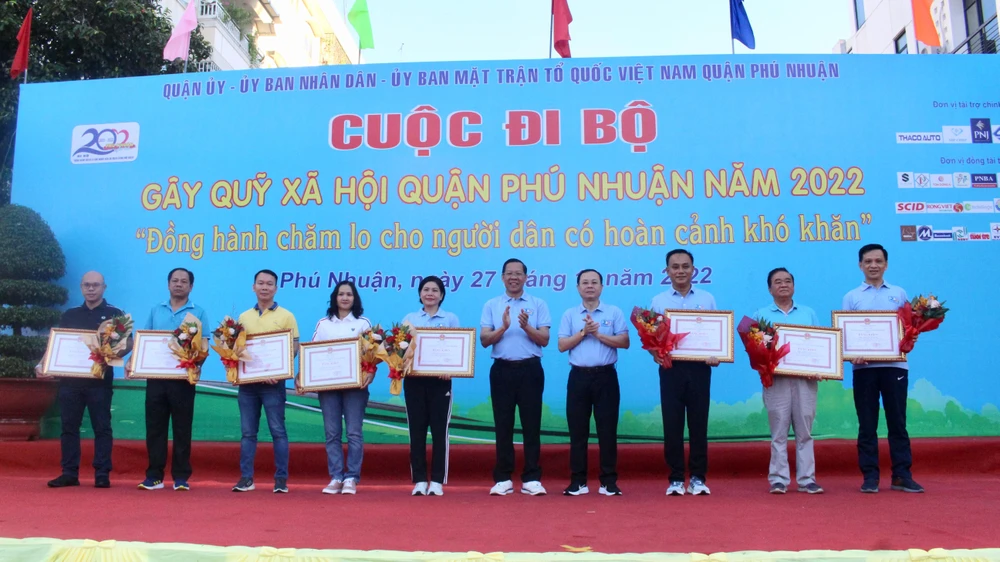 Ông Phan Văn Mãi, Chủ tịch UBND TP.HCM và ông Nguyễn Văn Hiếu, Phó Bí thư Thành uỷ trao bằng khen của UBND TP cho các tổ chức tại buổi lễ. Ảnh: NGUYỄN YÊN